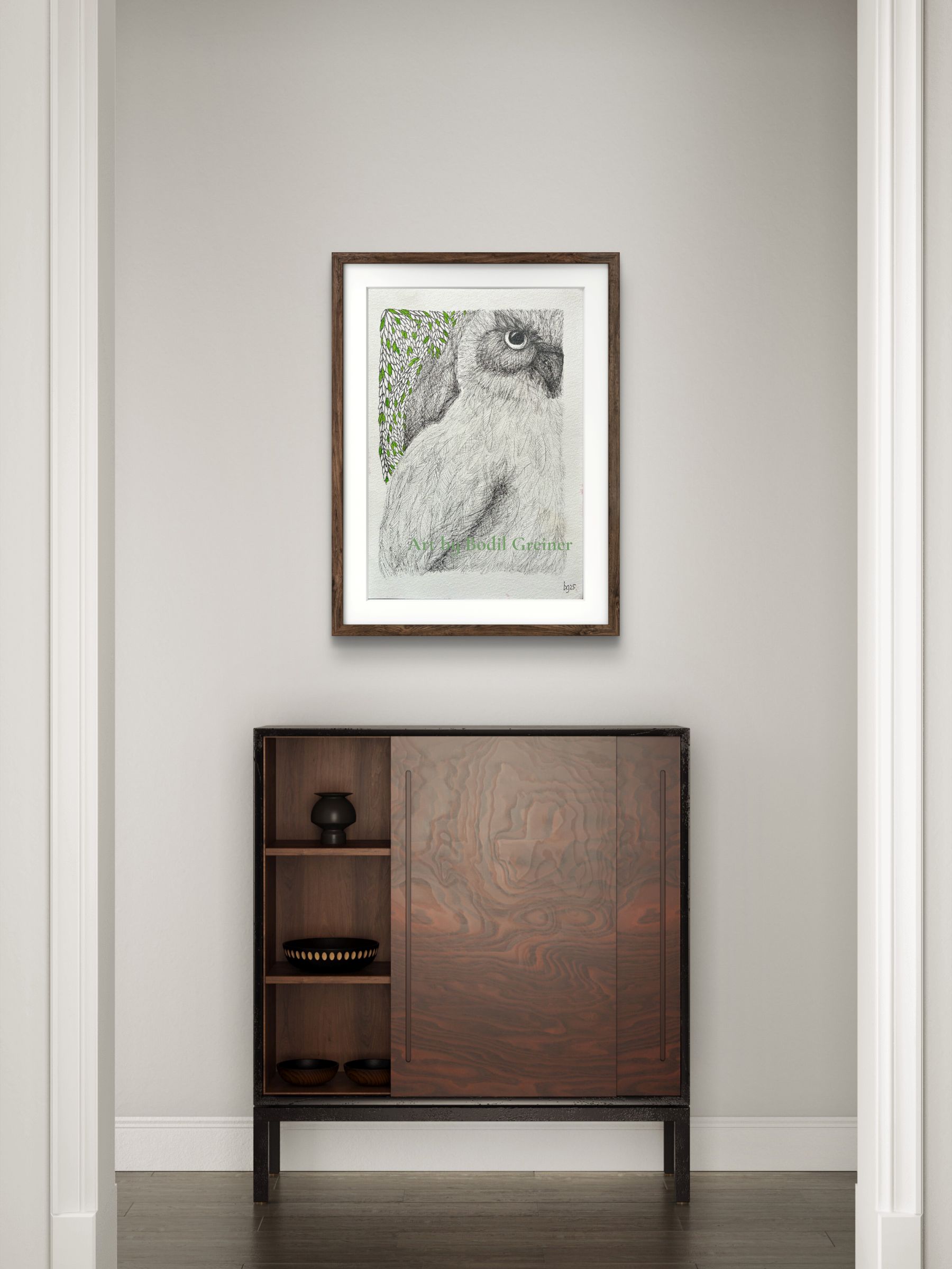 Framed original miniature fineliner owl art hanging on a living room wall